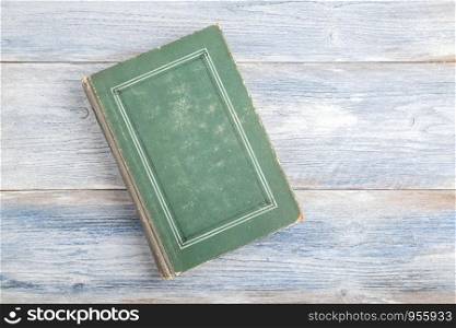 old book on light blue old wooden background. top view flat lay