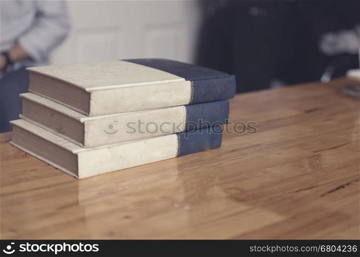 old book on wooden table in room, selective focus and vintage tone