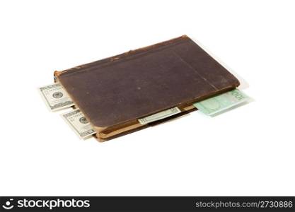Old book with banknote bookmarks isolated