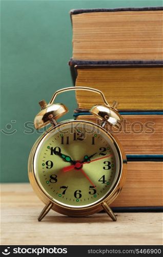 old books and alarm clock