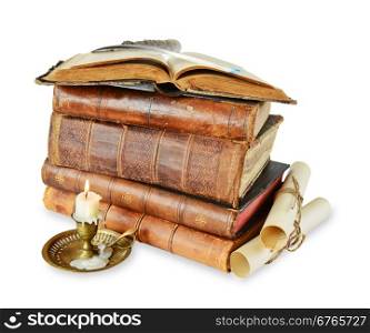 Old books, candle in candlestick, featherand scroll on a white background