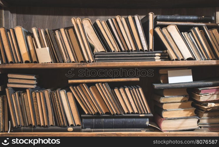 Old books in a vintage library shelfs