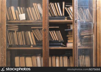 Old books in a vintage library shelves