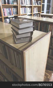 Old books in a vintage library shelves