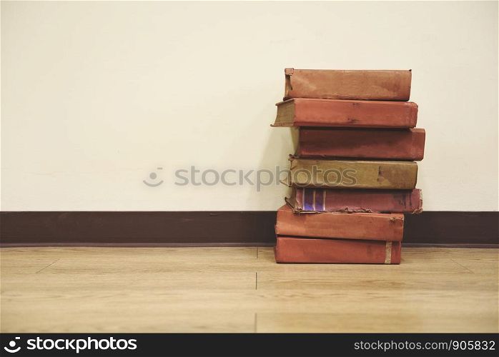 Old books on a wooden floor / Book stack in the library room for business and education wall background , back to school concept
