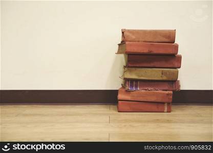 Old books on a wooden floor / Book stack in the library room for business and education wall background , back to school concept