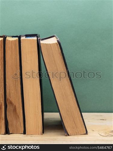 old books on a wooden shelf