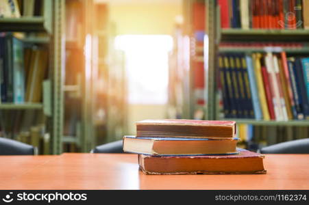 Old books on a wooden table / Book stack in the library room for business and education background , back to school concept