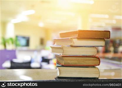 Old books on a wooden table / Open book stack in the library room for business and education background , back to school concept