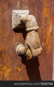 Old brass knocker shaped hand door