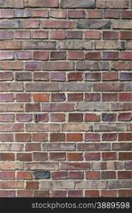 Old brick wall with different colored bricks