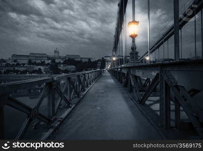 Old bridge at rainy night. Budapest, Hungary