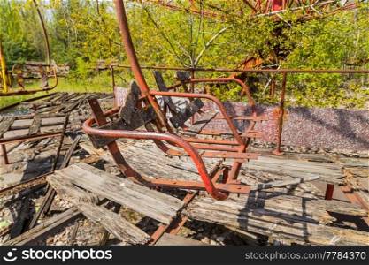 Old broken rusty metal radioactive children&rsquo;s electric wheel abandoned, the park of culture and recreation in the city of Pripyat, the Chernobyl disaster, Ukraine.