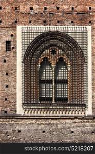 old brown castle brick and window in the grass of castle sforzesco milan