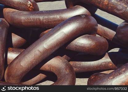 old brown chain on the ground in the street