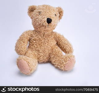 old brown teddy bear on a white background