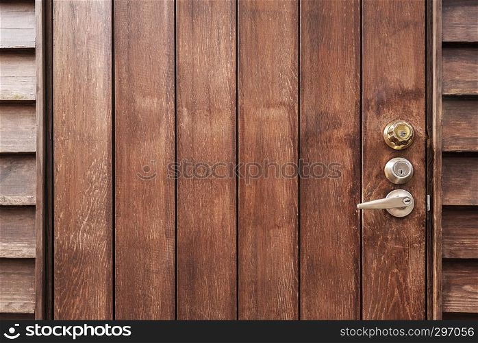 Old brown wooden door with knob and empty space for background. Abstract retro and vintage background.