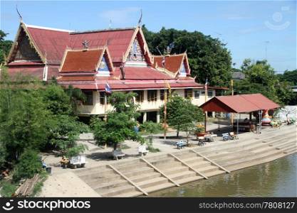 Old buddhist temple on the bank of river in Lop Buri, Thailand
