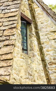 Old building window on stone wall background, architecture detail