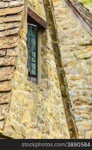 Old building window on stone wall background, architecture detail