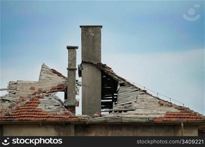 Old building with destroyed tiled roof.