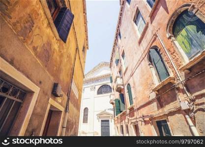 Old buildings in the city of Venice in Italy with weathered wall and retro windows