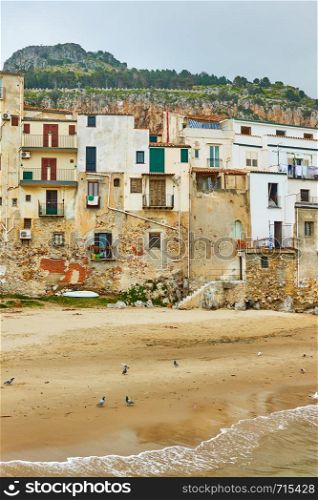 Old buildings on the beach in Cefalu, Sicily, Italy