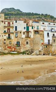 Old buildings on the beach in Cefalu, Sicily, Italy