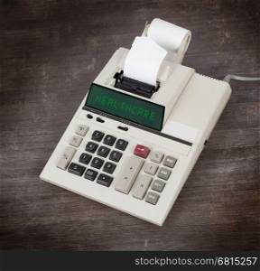 Old calculator showing a text on display - healthcare
