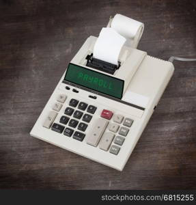 Old calculator showing a text on display - payroll