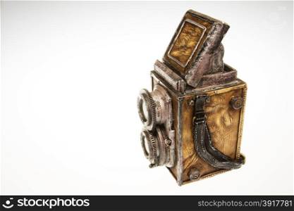 Old camera - model collector on isolated white.Model old fashioned SLR double objective system made of plaster and leather.Horizontal view from left side.Object on isolated white background in studio.