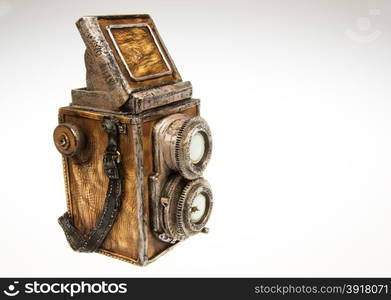 Old camera - model collector on isolated white.Model old fashioned SLR double objective system made of plaster and leather.Horizontal view from right side.Object on isolated white background in studio.