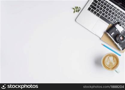 old camera notebook laptop with blue pencil cup cappuccino white background . Resolution and high quality beautiful photo. old camera notebook laptop with blue pencil cup cappuccino white background . High quality and resolution beautiful photo concept