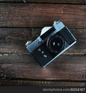 old camera on dark wooden background