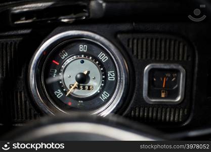 Old car dashboard and instrument claster on dark interior