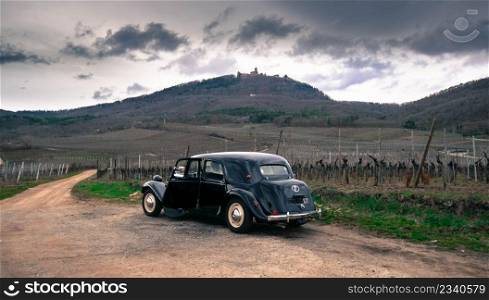Old car in the front of the Koenigsburg castle in Alsace in france
