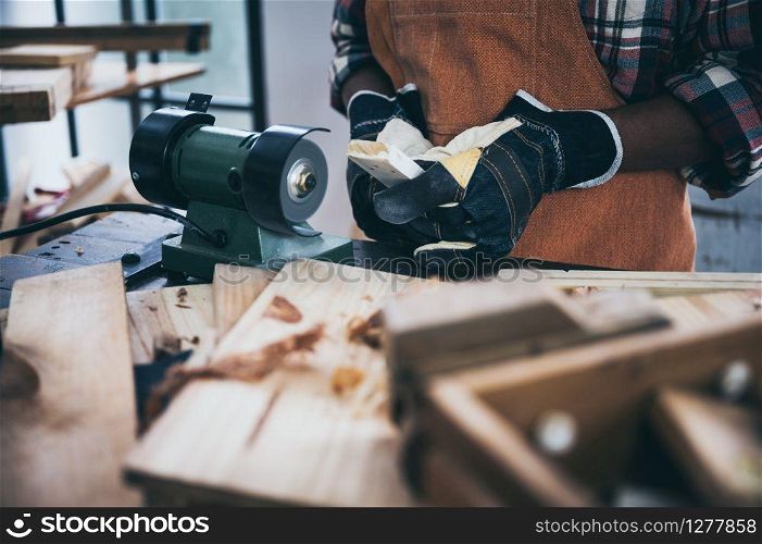 old carpenter man working in carpenter studio