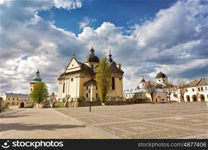 Old cathedral and church. Square in old town. Sunny cloudy cityscape