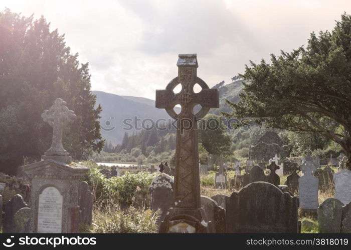 Old Celtic Cross in The Glendalough s Cemetery. Wicklow mountain, Ireland