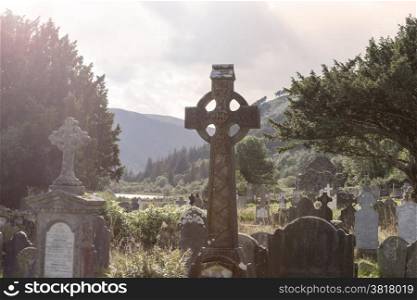 Old Celtic Cross in The Glendalough s Cemetery. Wicklow mountain, Ireland