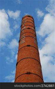 old chimney made of bricks on a dismantled industry