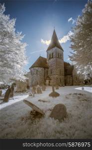 Old church in English countryside landscape in infrared