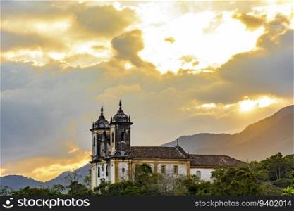 Old church on top of the hill and among the vegetation in the city of Ouro Preto in Minas Gerais. Old church on top of the hill and among the vegetation