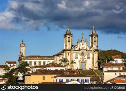Old church on top of the hill and between the houses in the city of Ouro Preto in Minas Gerais, Brazil. Old church on top of the hill and between the houses in Ouro Preto
