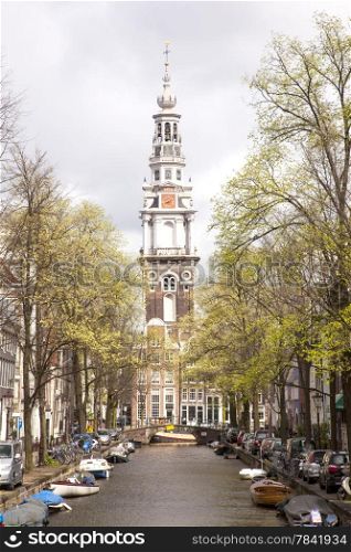 old church tower and canal in Amsterdam the Netherlands