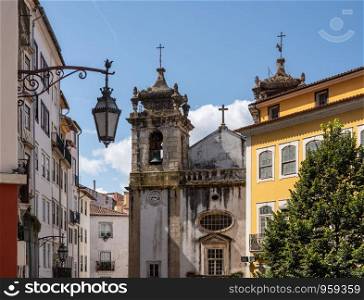 Old church tower of Sao Bartholomeu church in downtown Coimbra in Portugal. Crumbling bell tower of St Bartholomew church in Coimbra