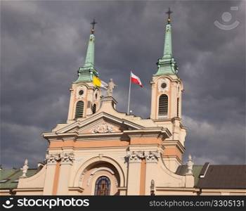 Old church with polish flags in Warsaw Poland