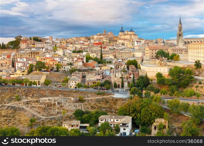 Old city of Toledo with Primate Cathedral of Saint Mary, churches of San Ildelfonso, San Roman and Santo Tome at sunset, Castilla La Mancha, Spain. Restoration of the Arab baths in the foreground