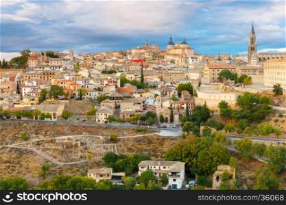 Old city of Toledo with Primate Cathedral of Saint Mary, churches of San Ildelfonso, San Roman and Santo Tome at sunset, Castilla La Mancha, Spain. Restoration of the Arab baths in the foreground