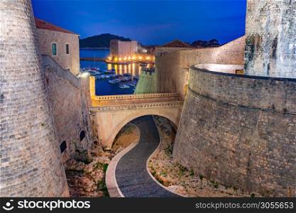 Old city walls and Old Harbour of Dubrovnik at night in Dubrovnik, Croatia. Old Harbor of Dubrovnik, Croatia